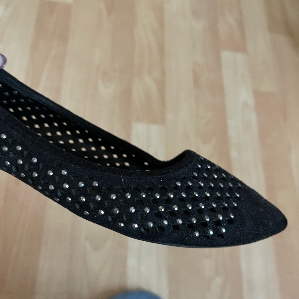 Black flat shoes with silver embellishments